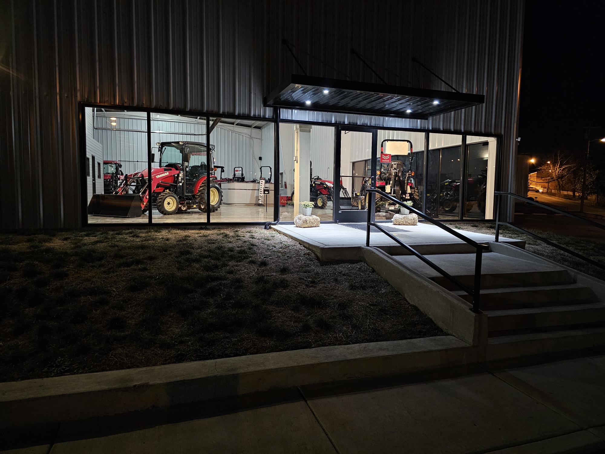 Night photo of Tractor Town building showcases the interior of the building